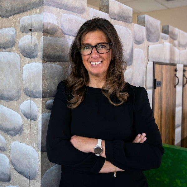 Barbara Thompson standing in front of the play castle.